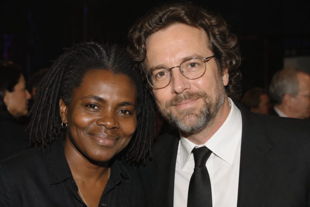 A couple dressed in formal attire smiling together at a public event, representing a discussion about Tracy Chapman's personal life and relationship status.