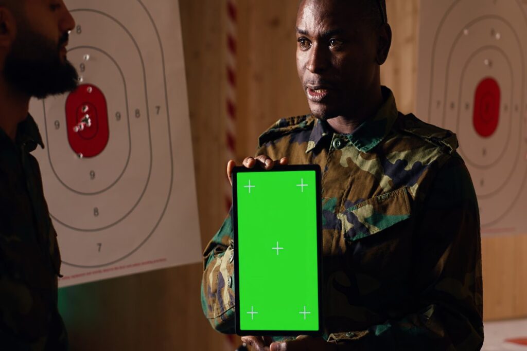 Smartphone displaying the GunBroker mobile app with product listings, auction details, saved items, bidding features, and an intuitive mobile interface.