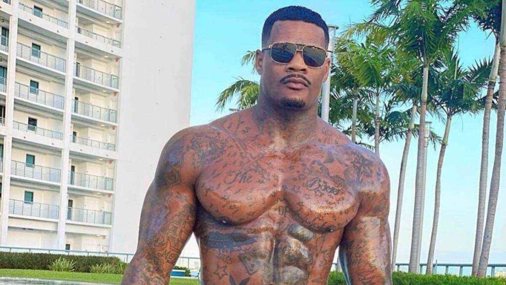 Jason Luv poses confidently in fashionable clothing, representing his career as a fitness model, entertainer, and social media personality.