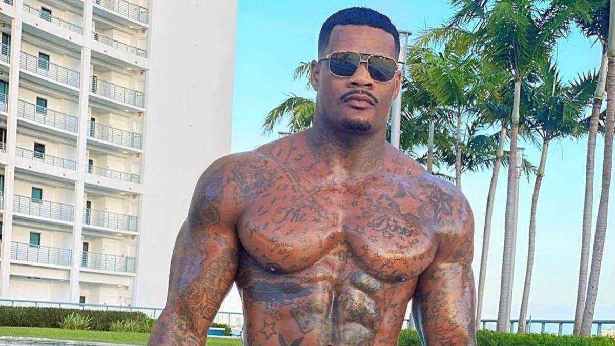 Jason Luv poses confidently in fashionable clothing, representing his career as a fitness model, entertainer, and social media personality.